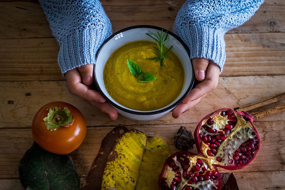 Winter-wellbeing Female holding bowl of soup.